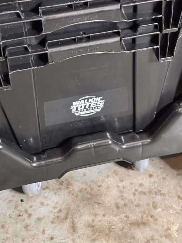 Close-up of the hot-stamped Walkin' Totes Rentals logo on a black moving tote